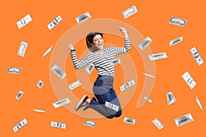 Woman jumping with clenched fist, celebrating winning lottery, money rain, dollars falling.