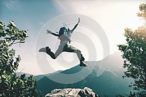 Woman jumping on cliff`s edge