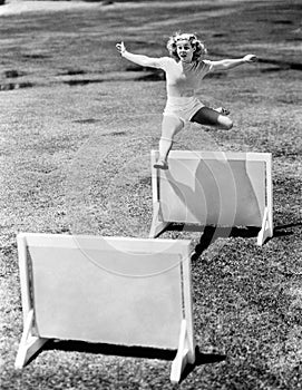 Woman jumping hurdles labeled with years photo
