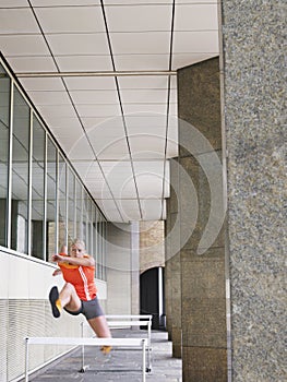 Woman Jumping Hurdles In Portico