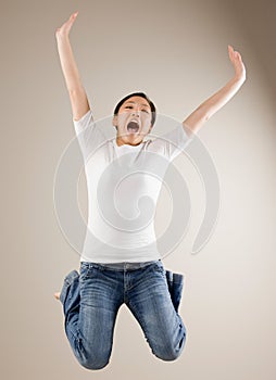 Woman jumping in mid-air cheering