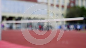 Woman jumping over bar at athletics meeting