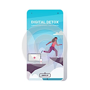 Woman jumping over cliff abyss running away from gadgets digital detox concept