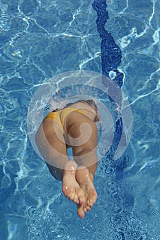 A woman jumping in the pool a summer day