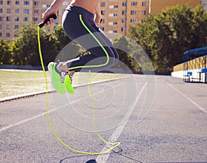 Woman with jumping rope. Beautiful young woman with a jumping rope in her hands