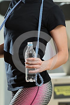 Woman With Jumping Rope And Bottle Of Water