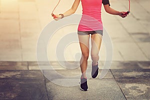 Woman jumping rope on city
