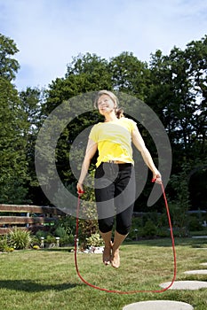 Woman jumping rope in the garden