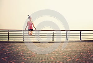 Woman jumping rope on seaside