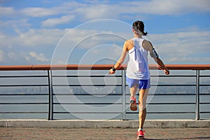 woman jumping rope at seaside