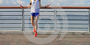 Woman jumping rope at seaside