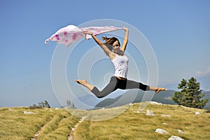 Woman jumping with a scarf