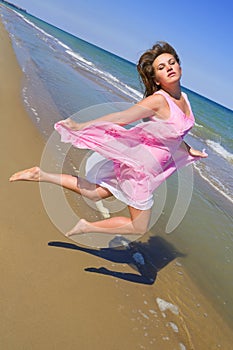 Woman jumping at the sea beach