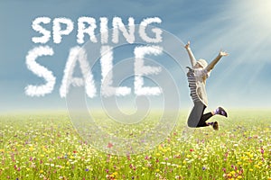 Woman jumping with text of spring sale