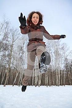 Woman jumps forward, winter day