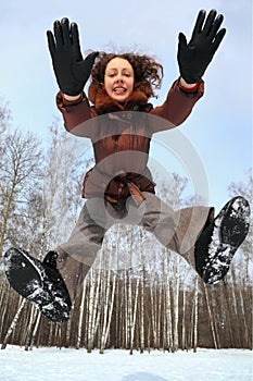 Woman jumps forward, winter day