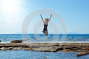 Woman  jumps high on the beach