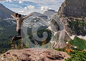 Woman Jumps for Joy Above Grinnell Lake