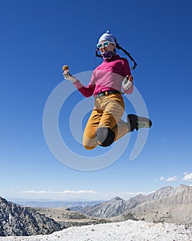 Woman Jumps On Mountain Top