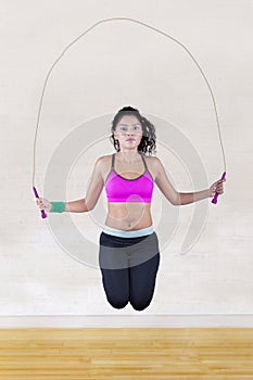 Woman jumps with skipping rope
