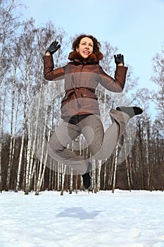 Woman jumps up to sky, winter