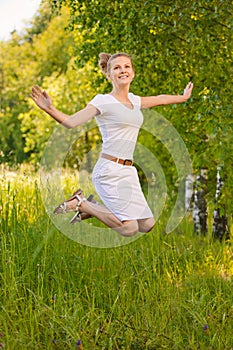 Woman jumps upwards and laughs