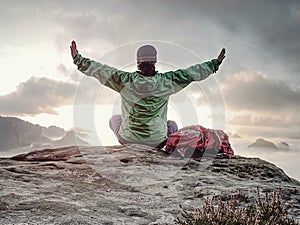 Woman just enjoying the life. Beautiful girl backpacker sit on top