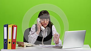 Woman is justified by boss by telephone. Green screen