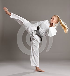 Woman karate actively working legs.