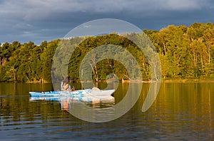 Woman Kayaking With Golden Light at Dusk