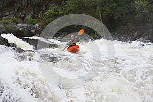 Woman kayaking in river