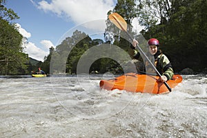 Woman kayaking in river