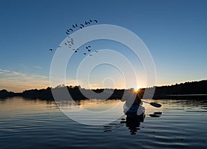 Woman Kayaking at Sunset