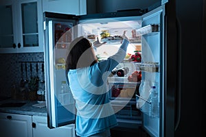 Woman Keeping Food In Refrigerator