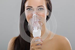 Woman keeping inhale mask