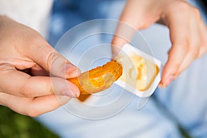 Woman keeping suace with potatoes in hands