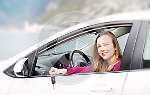 Woman with keys of new rental car