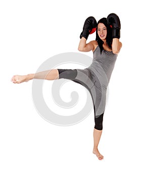 Woman in kick boxing action fighting