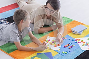 Woman and kid solving puzzle