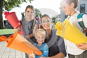 Woman and kids at enrolment day with school cones