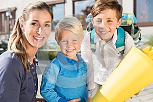 Woman and kids at enrolment day with school cones