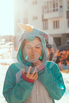 Woman in kigurumi unicorn costume