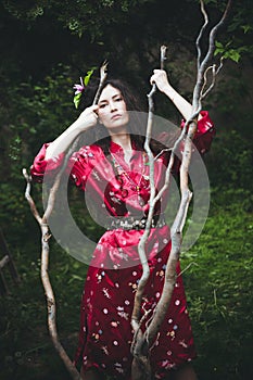 Woman in kimono in garden