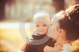 Woman kiss child with love. Mother and little son. Mom and baby boy outdoor. Mothers day concept. Happy family enjoy