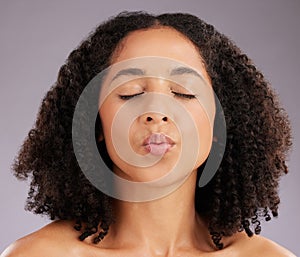 Woman, kiss face and beauty, flirt on studio background with dermatology and eyes closed. Makeup, natural cosmetics and