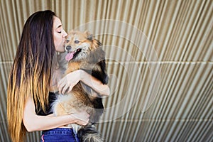 Woman kissing dog with copy space for text