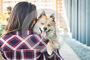 Woman kissing dog with copy space for textv