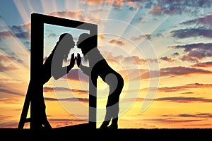 Woman is kissing her reflection in the mirror