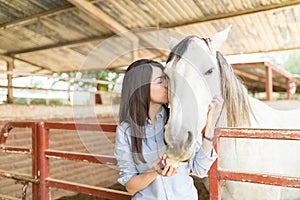 Woman Kissing Horse During Equine Therapy