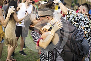 Woman Kissing Man in Live Music Concert Festival